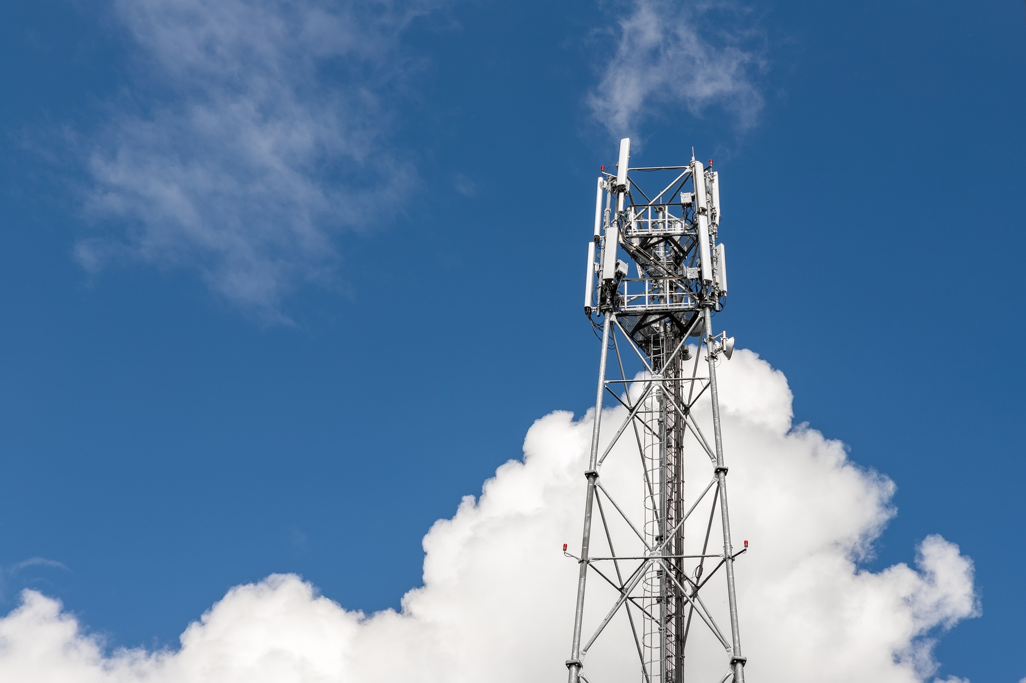 Bottom perspective pov of modern metal steel mobile 5g network wireless telecom tower against clear