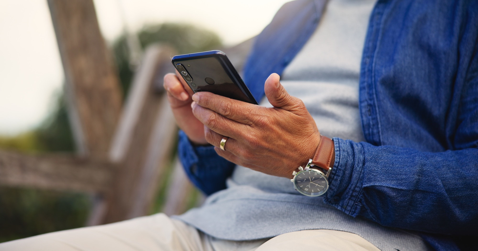 Phone, hands and closeup of senior man networking on social media. mobile app or the internet. Tech